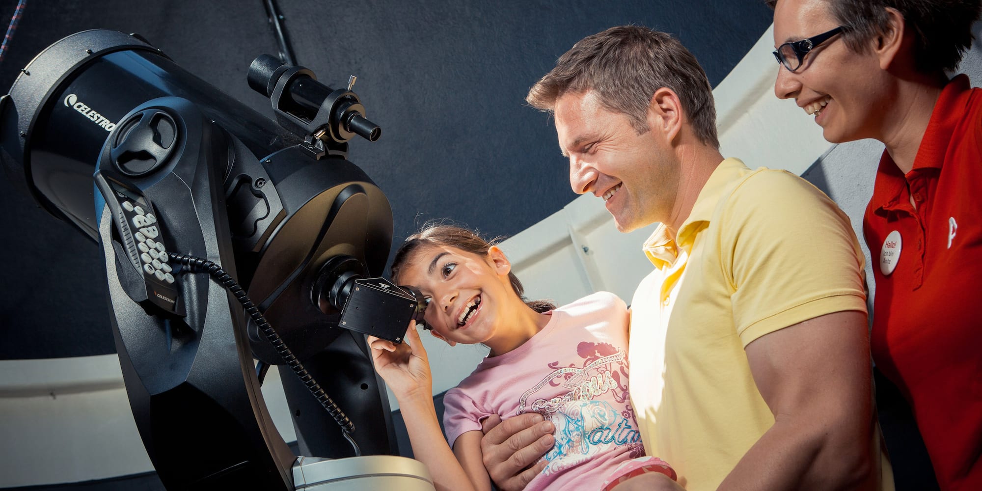 a man and woman looking at a microscope