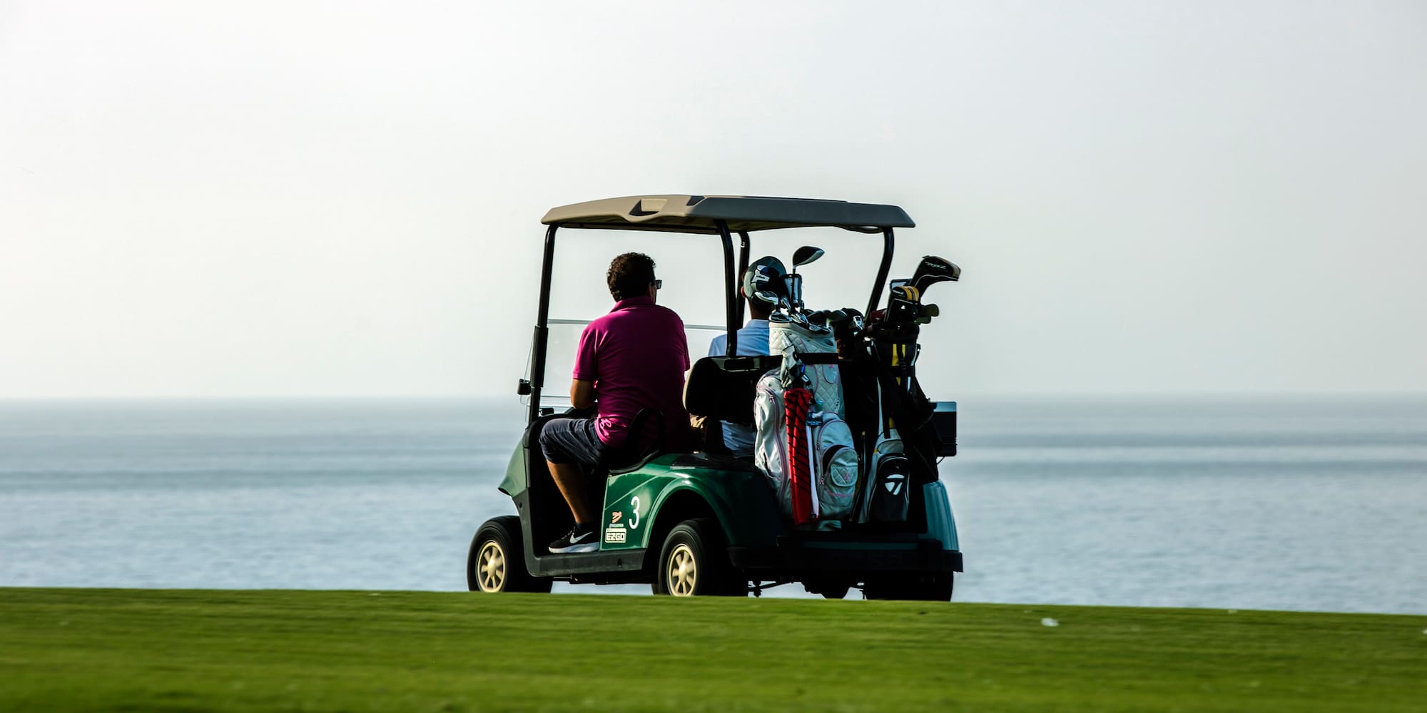 a group of people on a golf cart