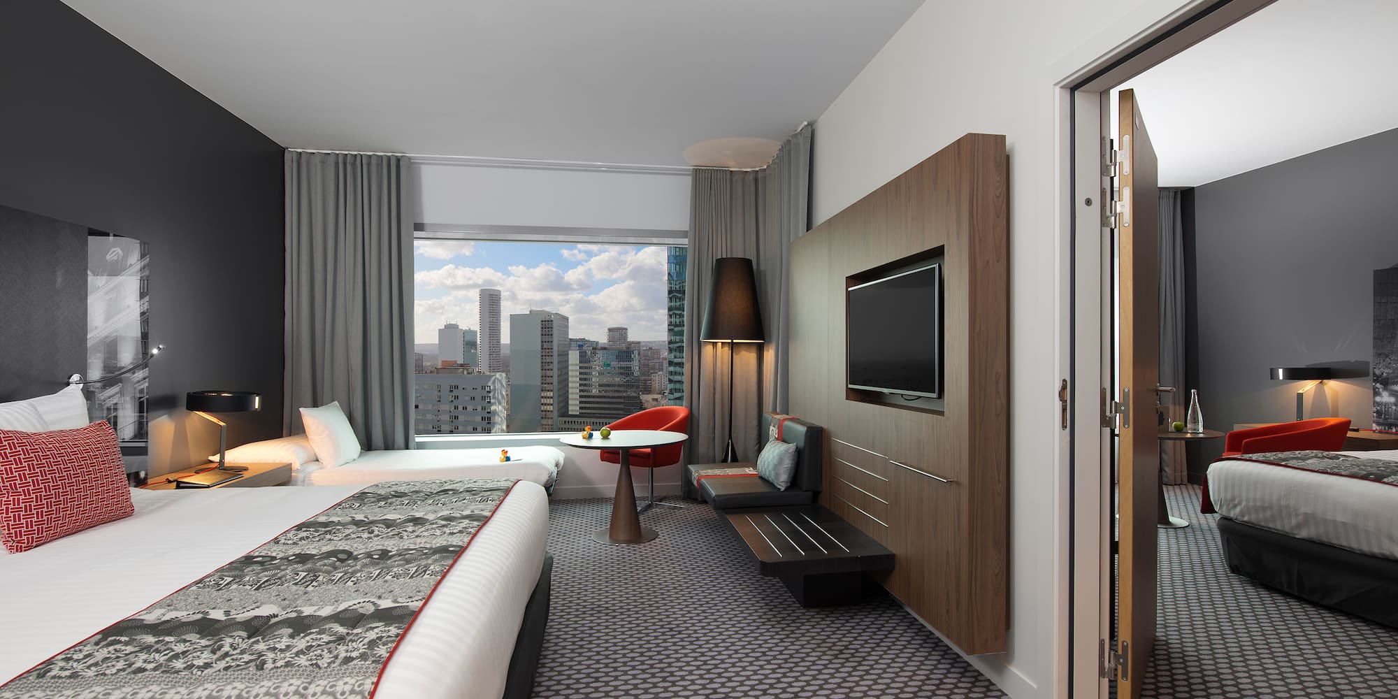 a room with a bed and a television