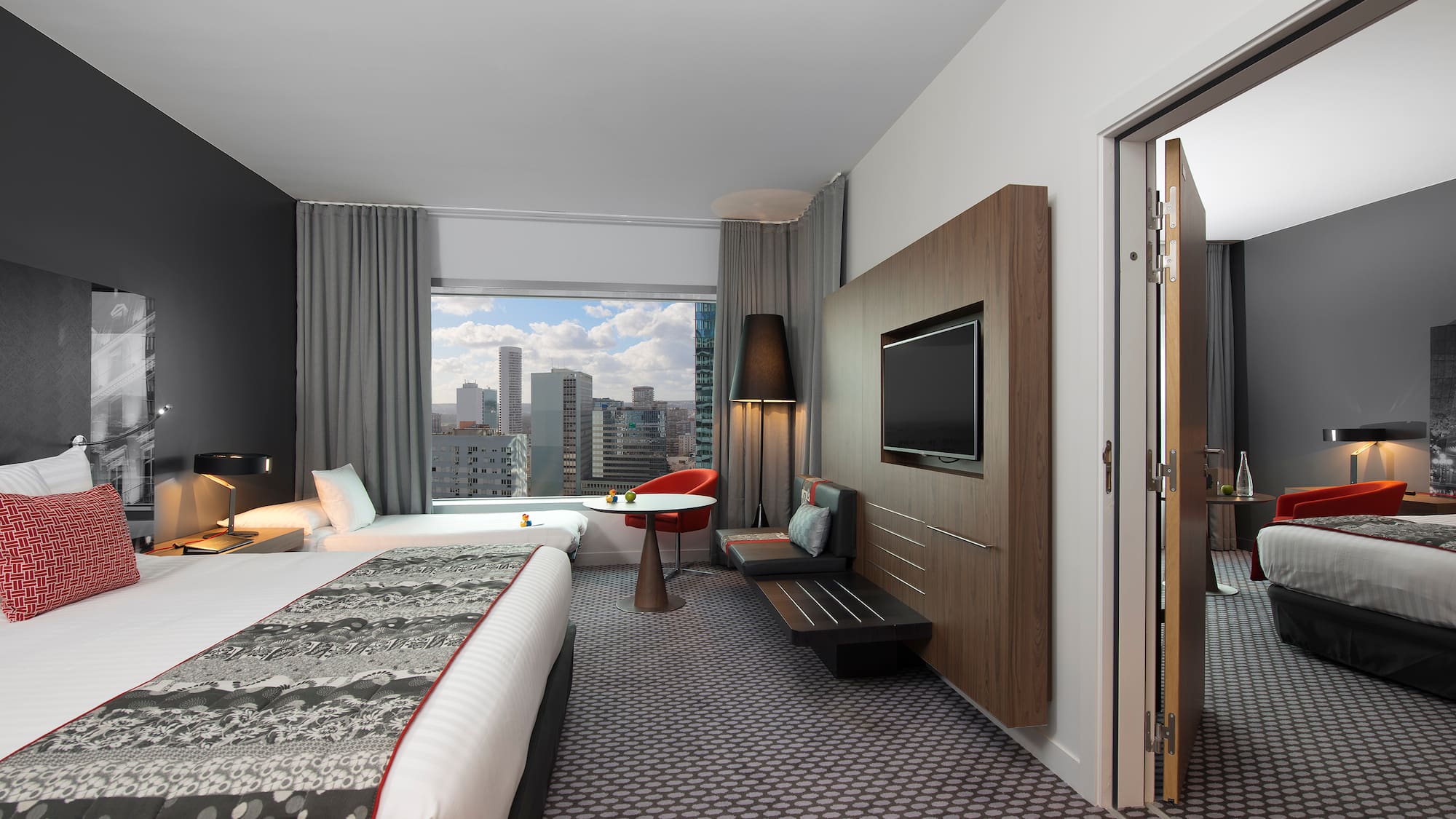 a room with a bed and a television