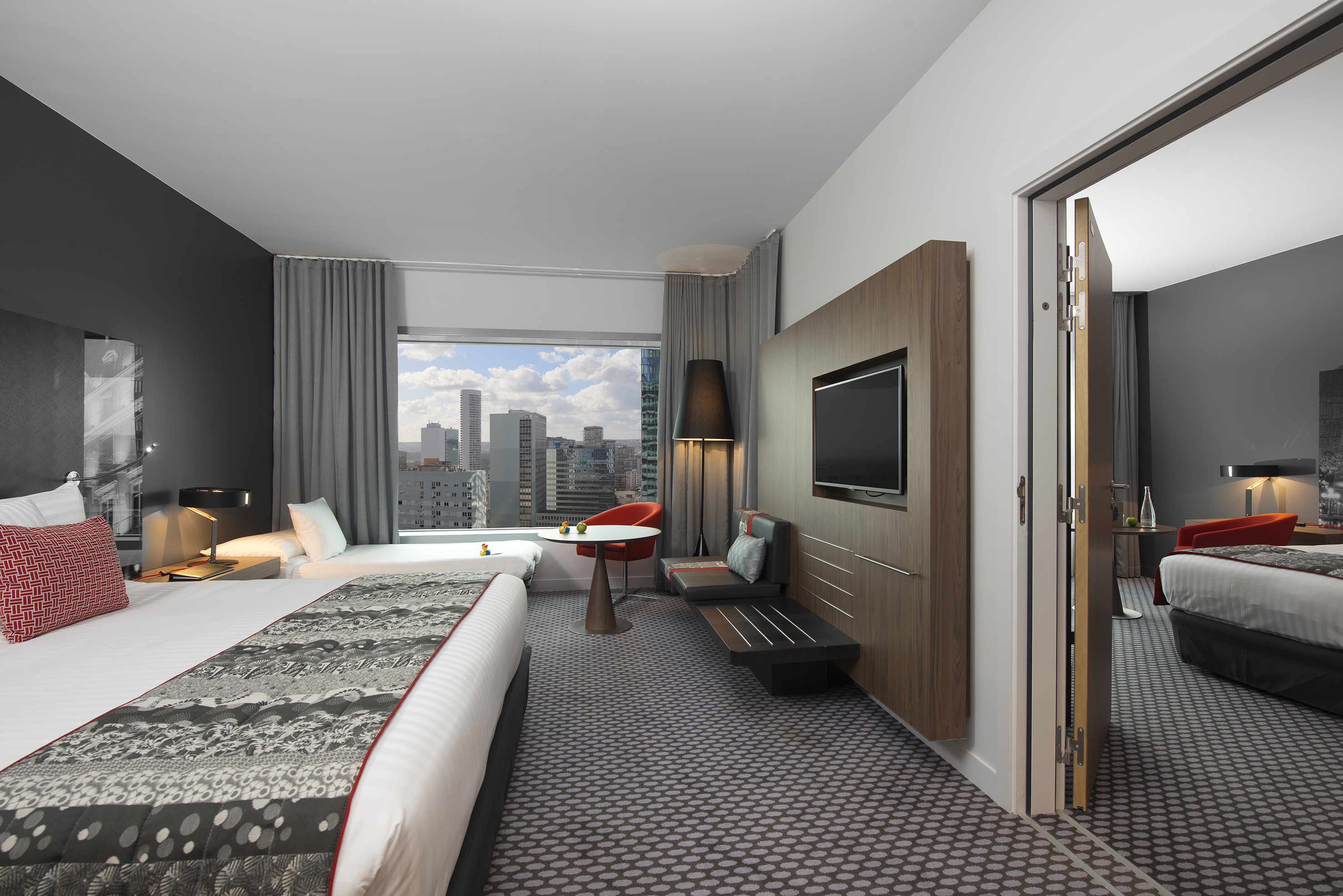 a room with a bed and a television