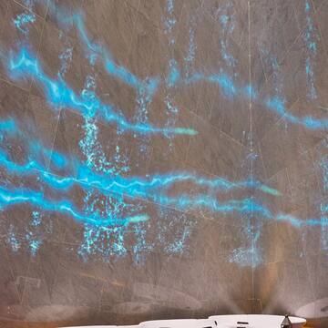 a blue light streaks on a wall