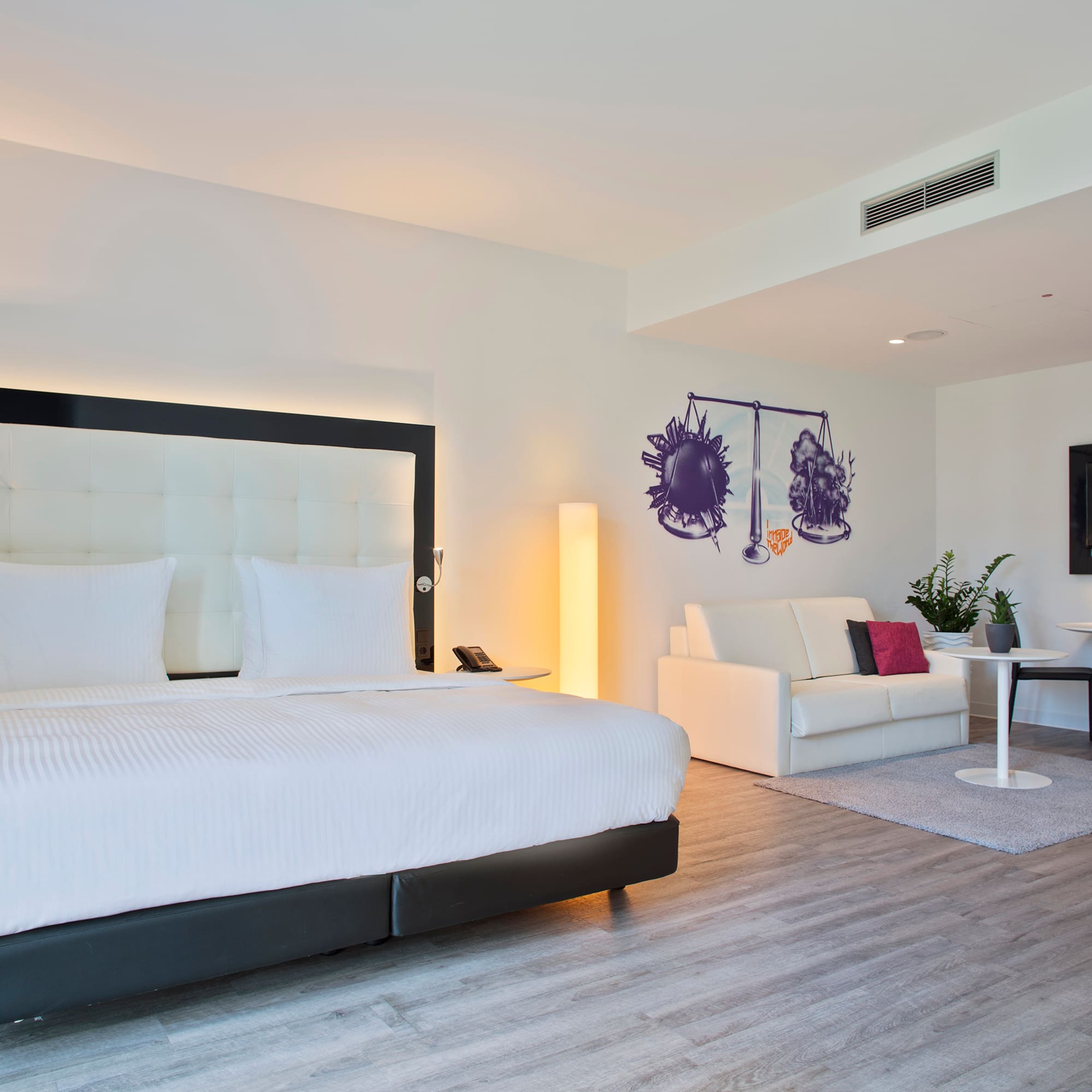 a room with a bed and a tv