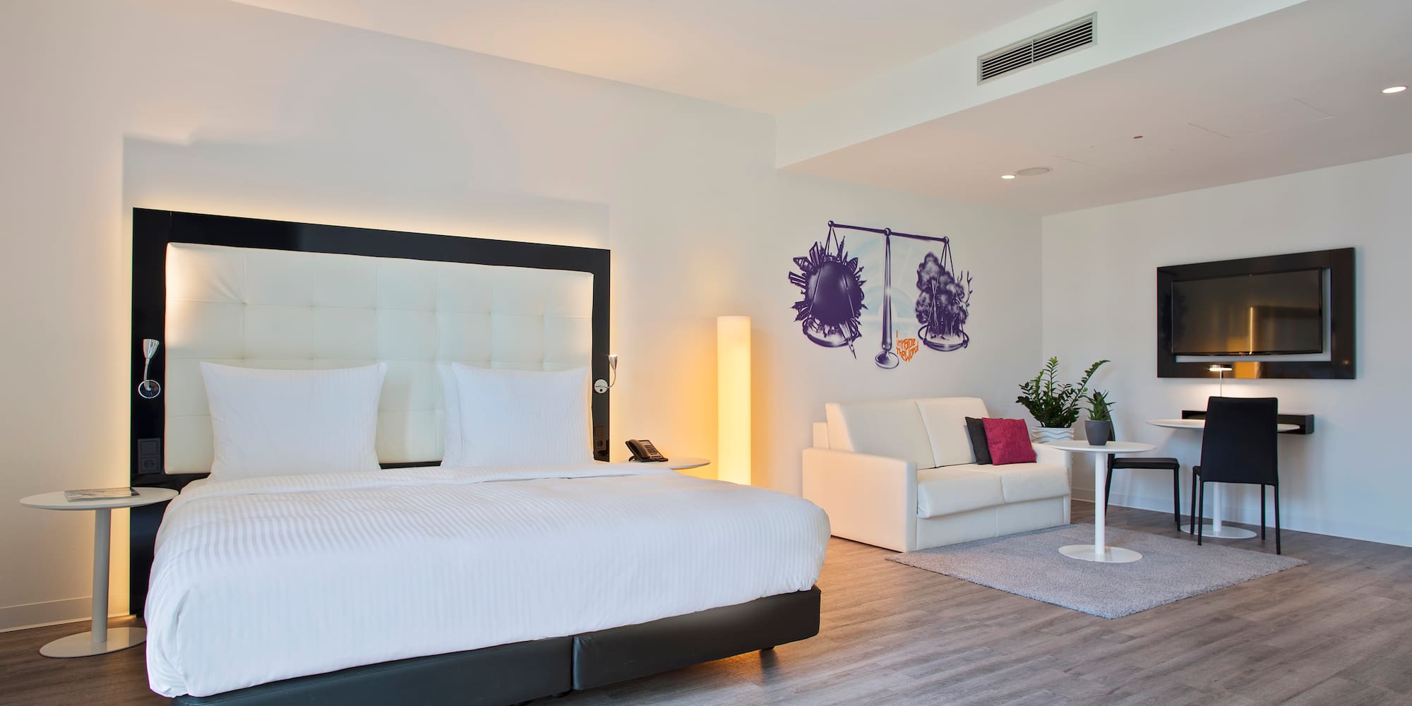 a room with a bed and a tv