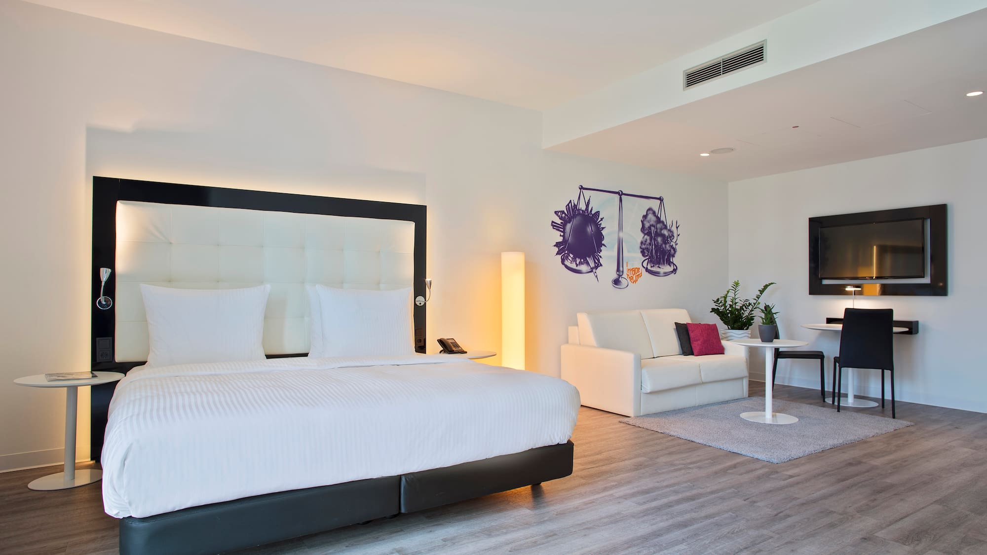 a room with a bed and a tv