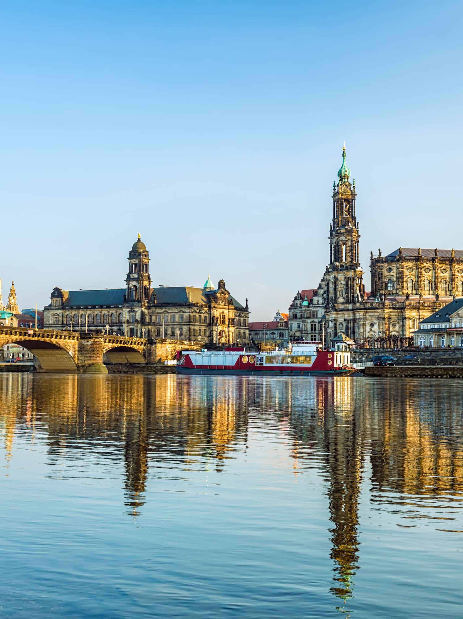 a body of water with a bridge and buildings