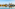 a body of water with a bridge and buildings