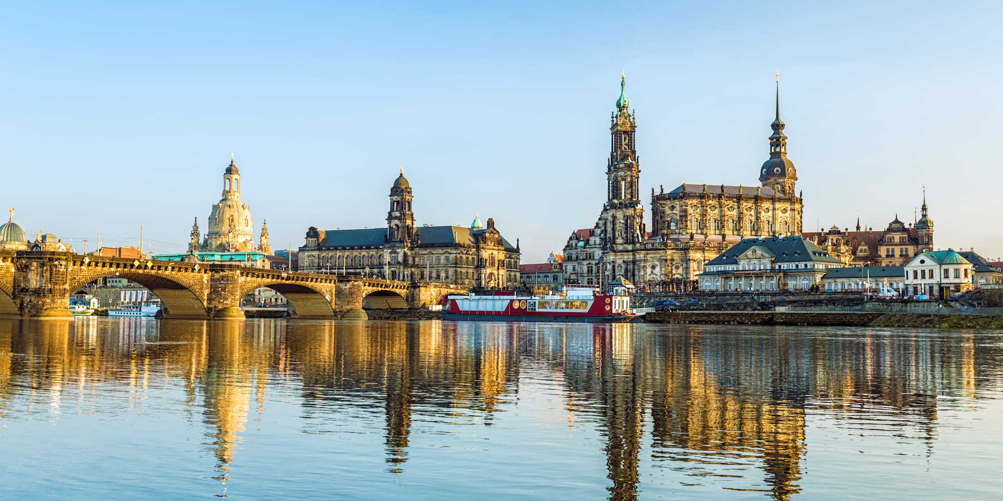 a body of water with a bridge and buildings