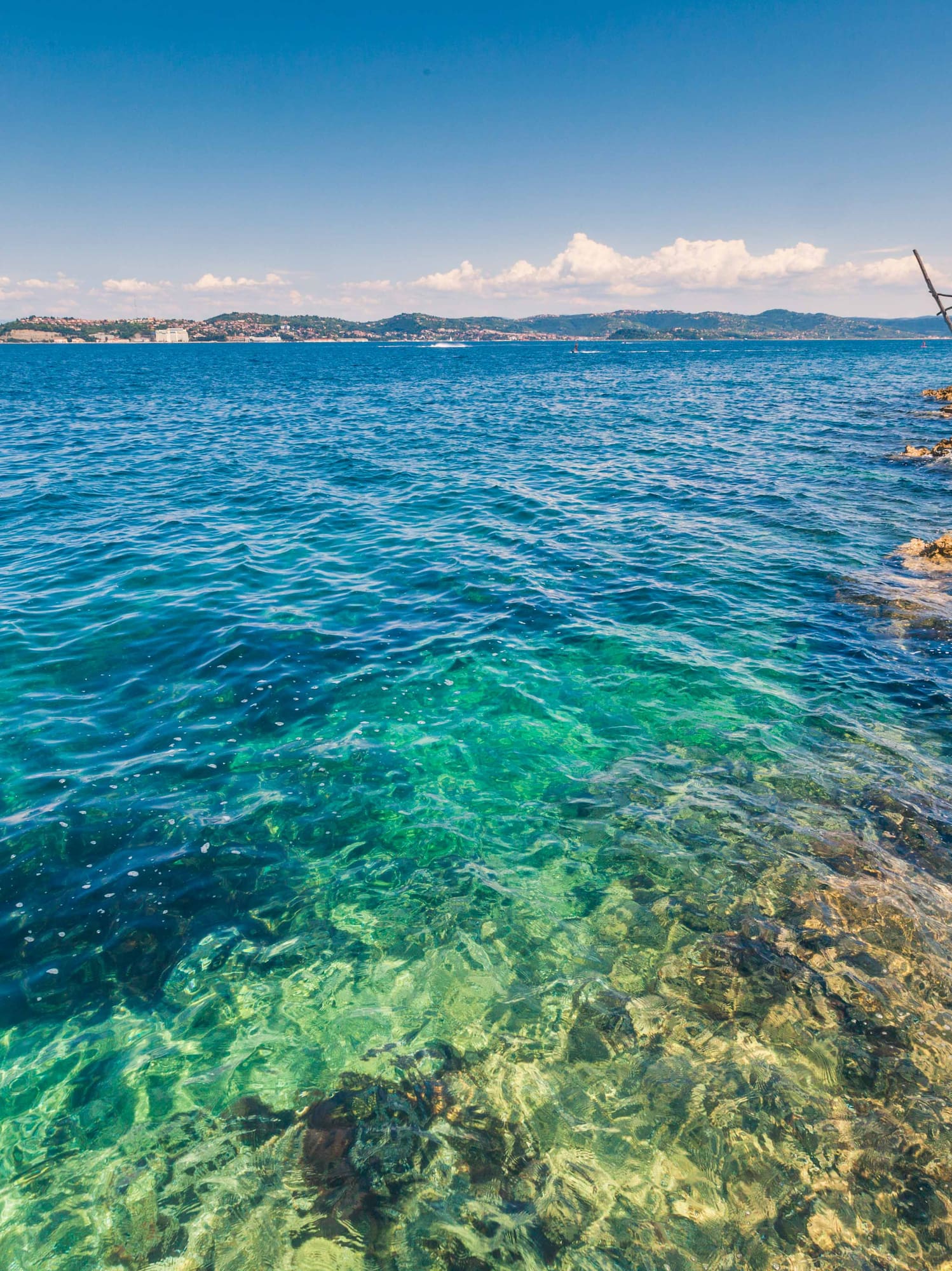 a body of water with rocks and a dock