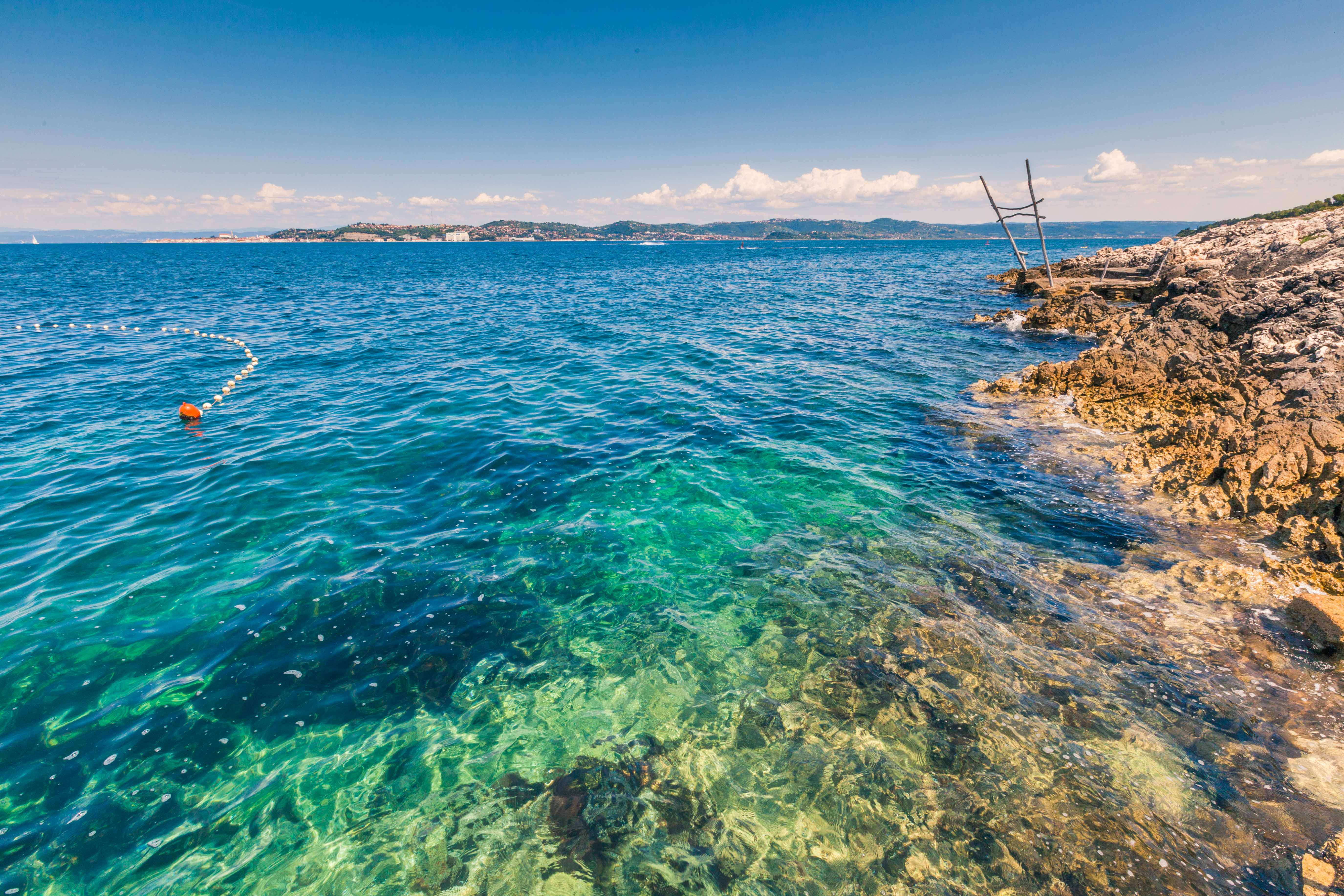 a body of water with rocks and a dock