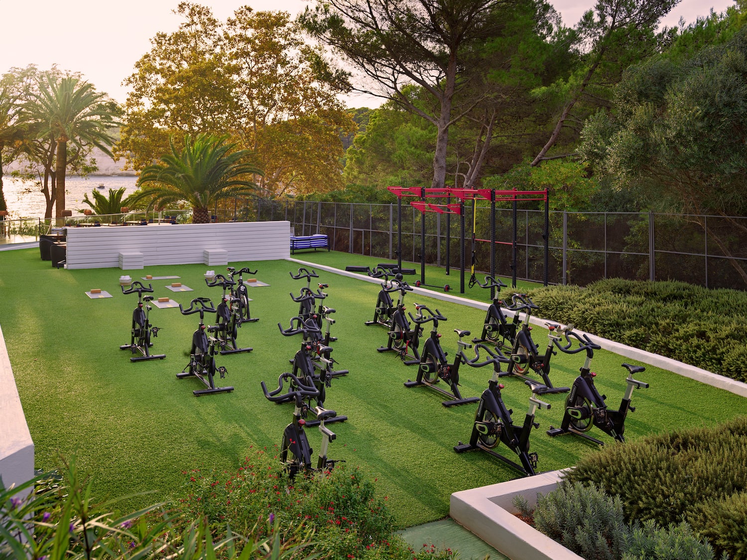 a group of exercise bikes on a green field