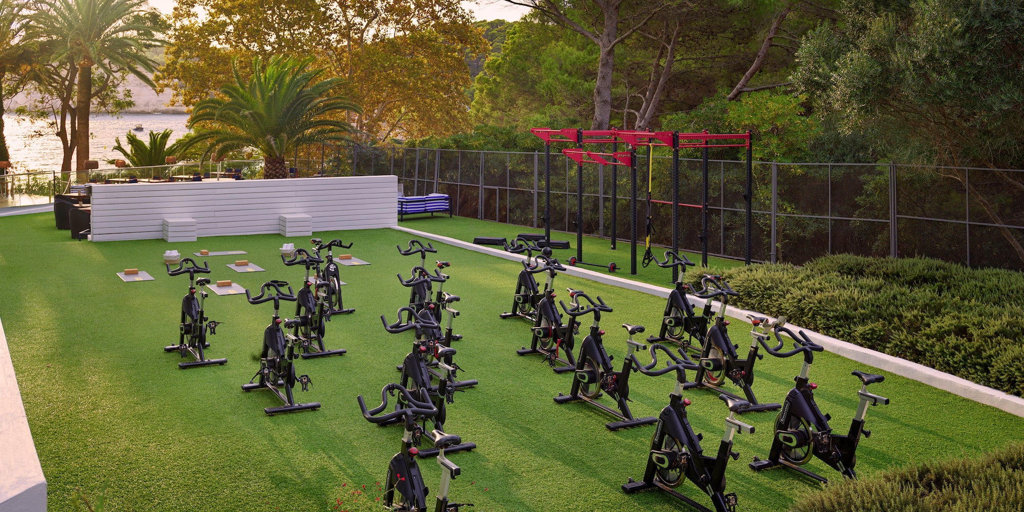 a group of exercise bikes on a green field