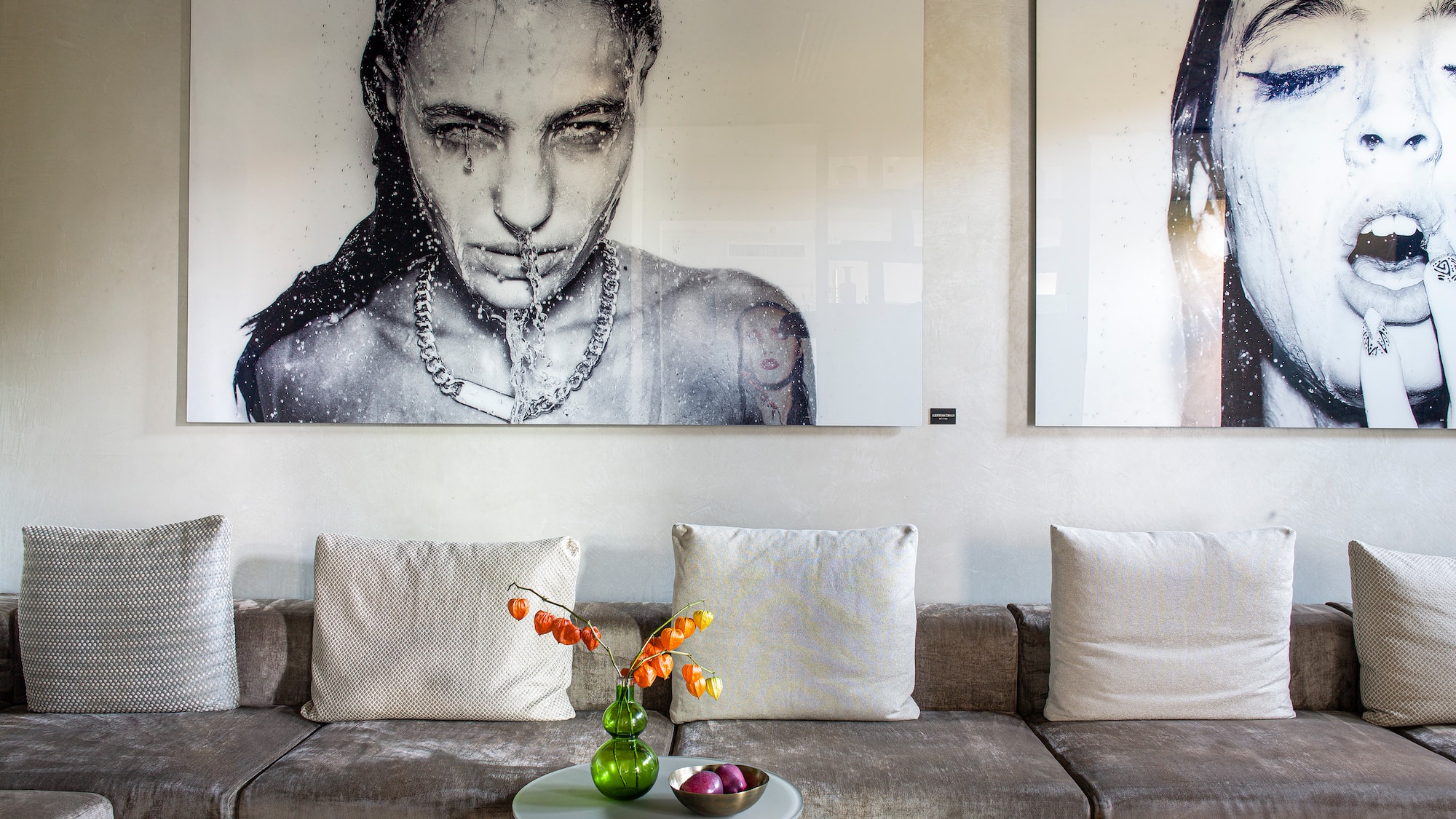 a couch with a table and pictures on the wall