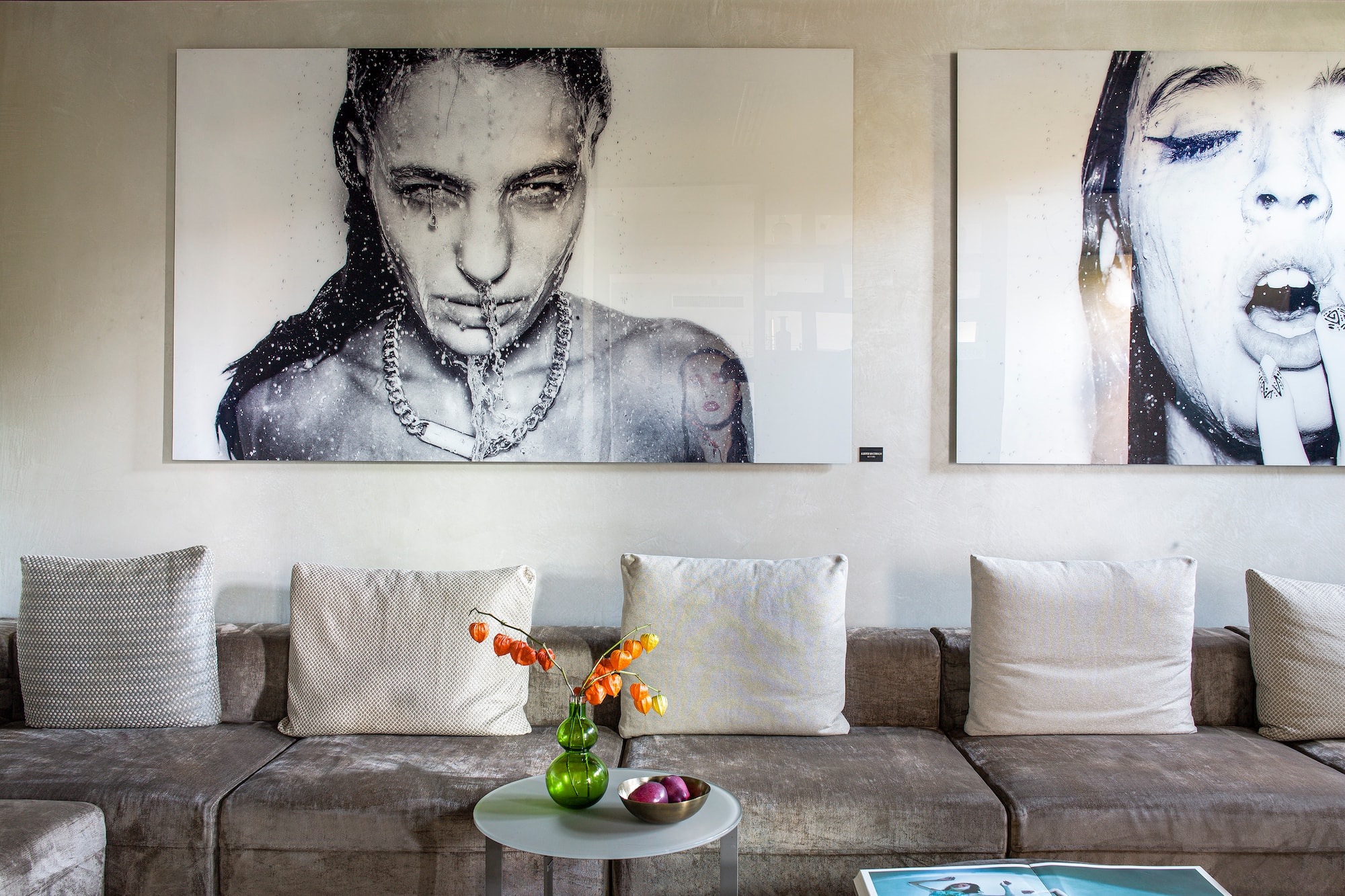 a couch with a table and pictures on the wall