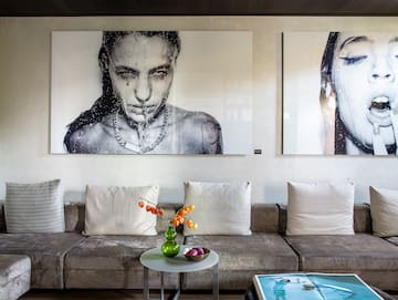 a couch with a table and pictures on the wall