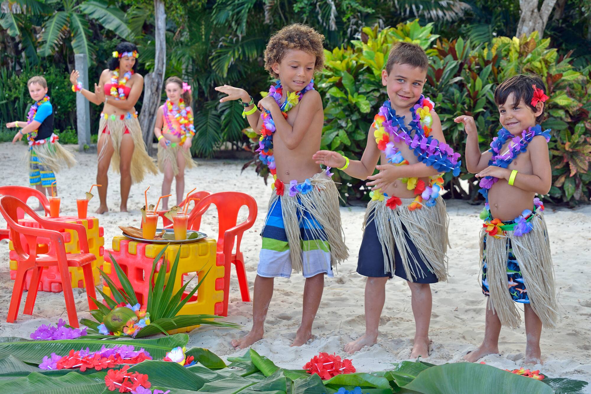 a group of kids wearing grass skirts and flowers