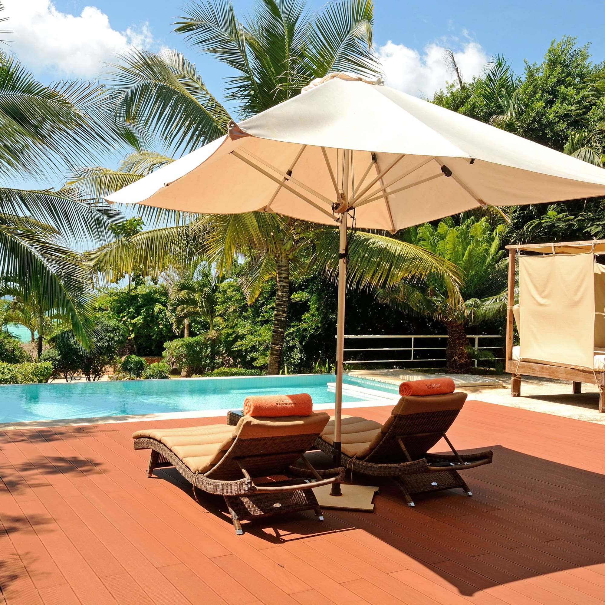a pool with lounge chairs and umbrella