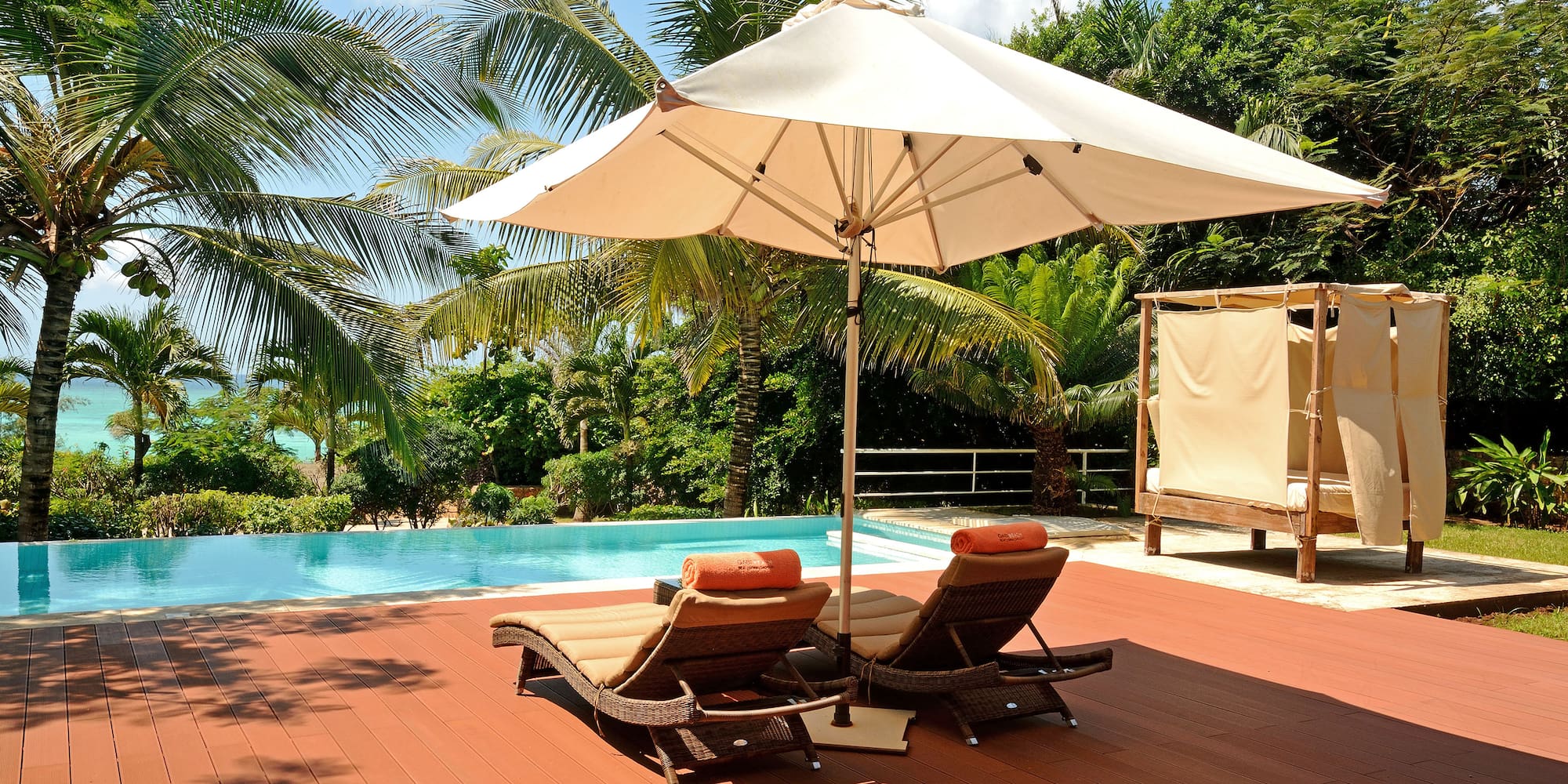 a pool with lounge chairs and umbrella