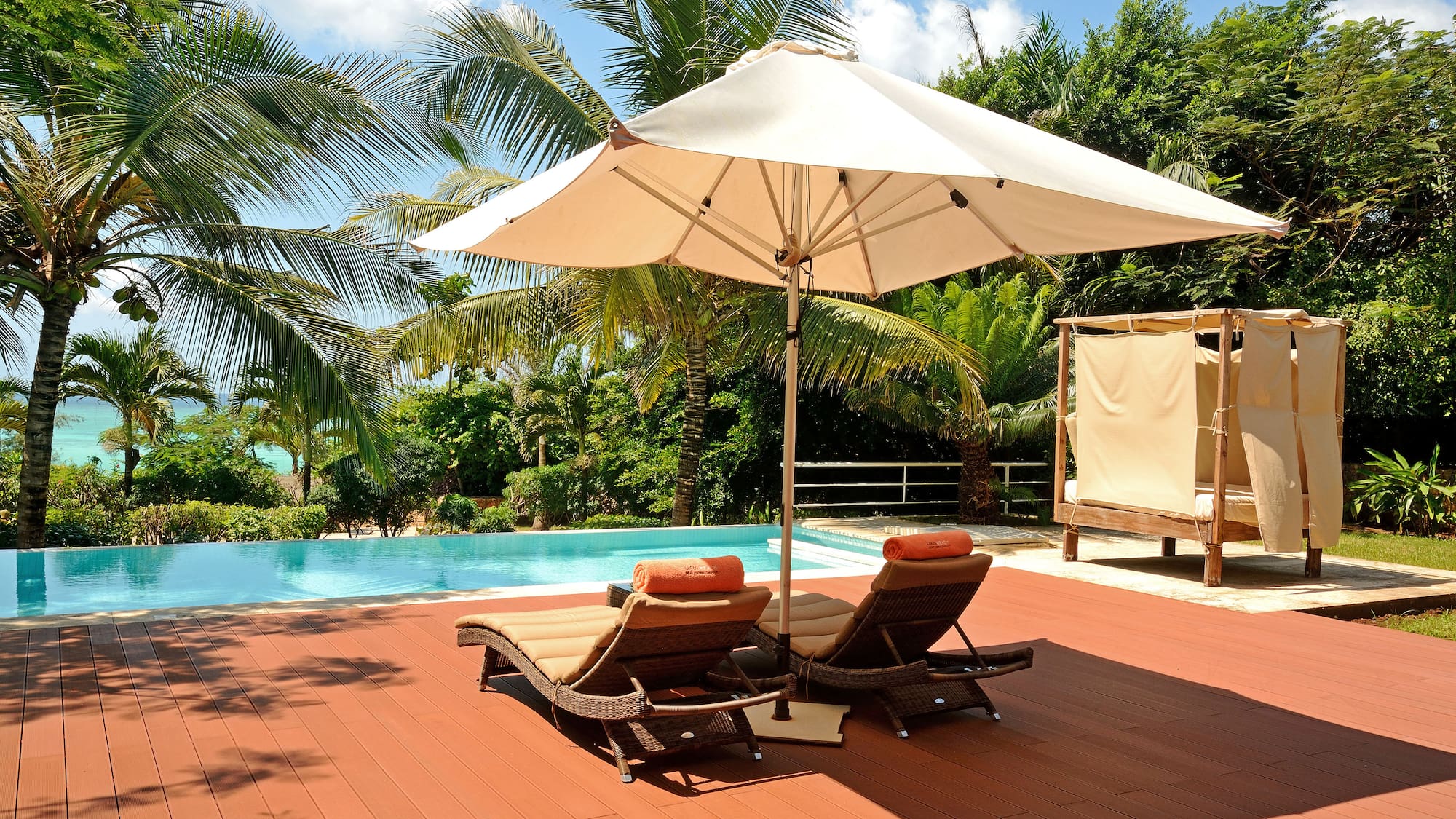 a pool with lounge chairs and umbrella