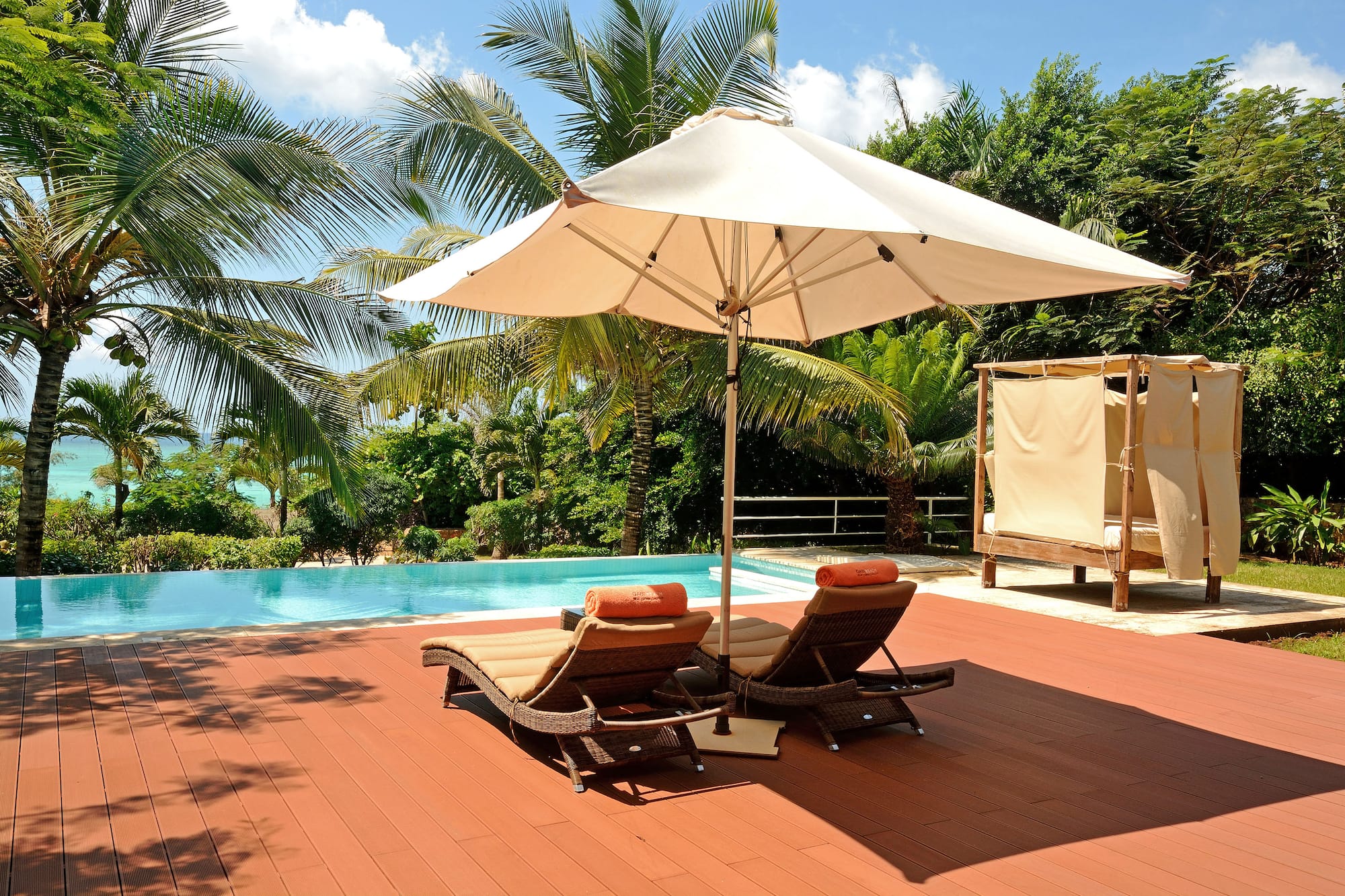 a pool with lounge chairs and umbrella