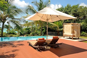 a pool with lounge chairs and umbrella