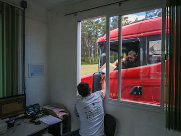 a man holding a box in a window