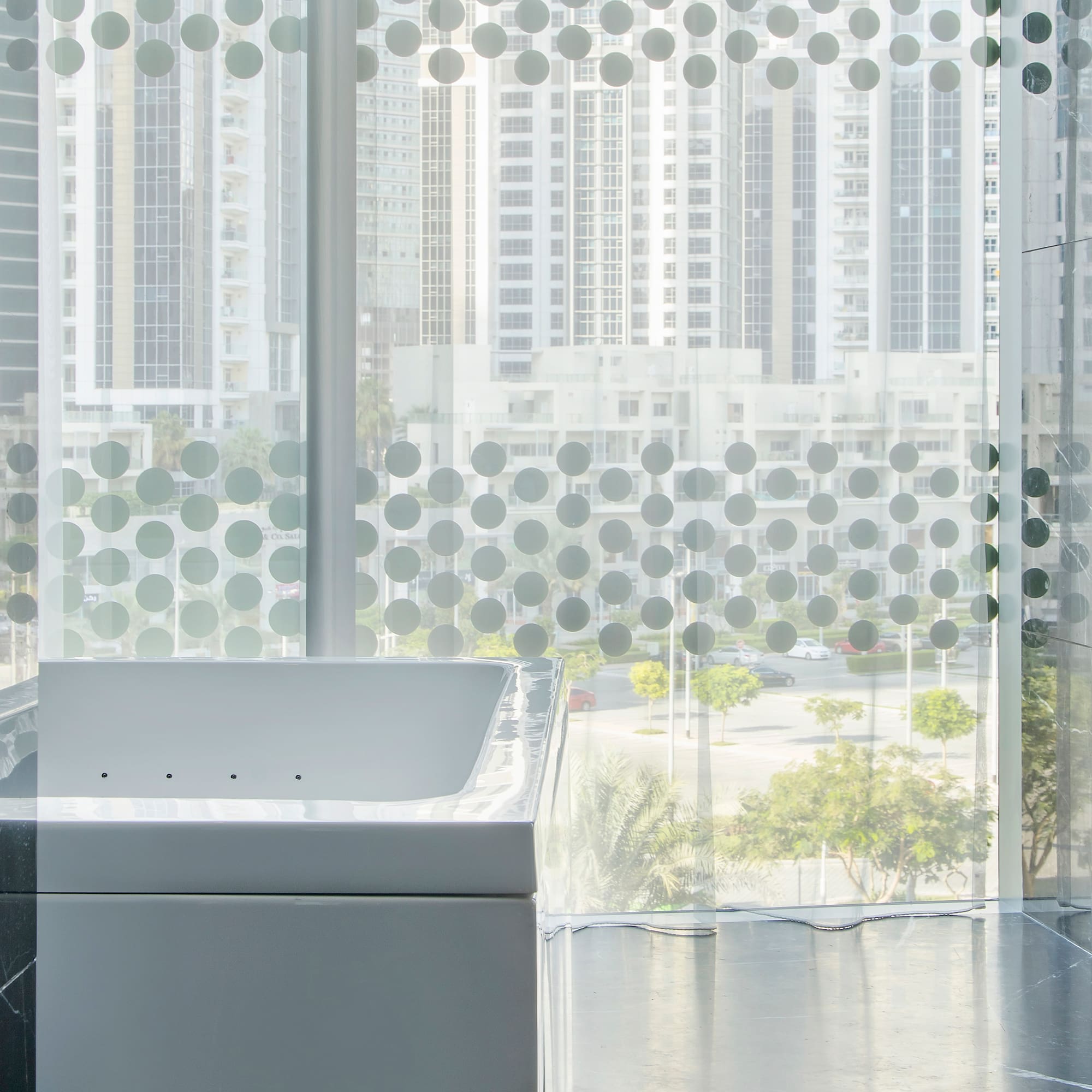 a bathtub in a room with a window and a city view