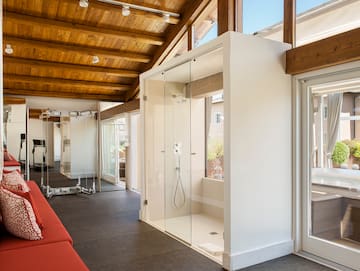 a room with glass doors and a red couch