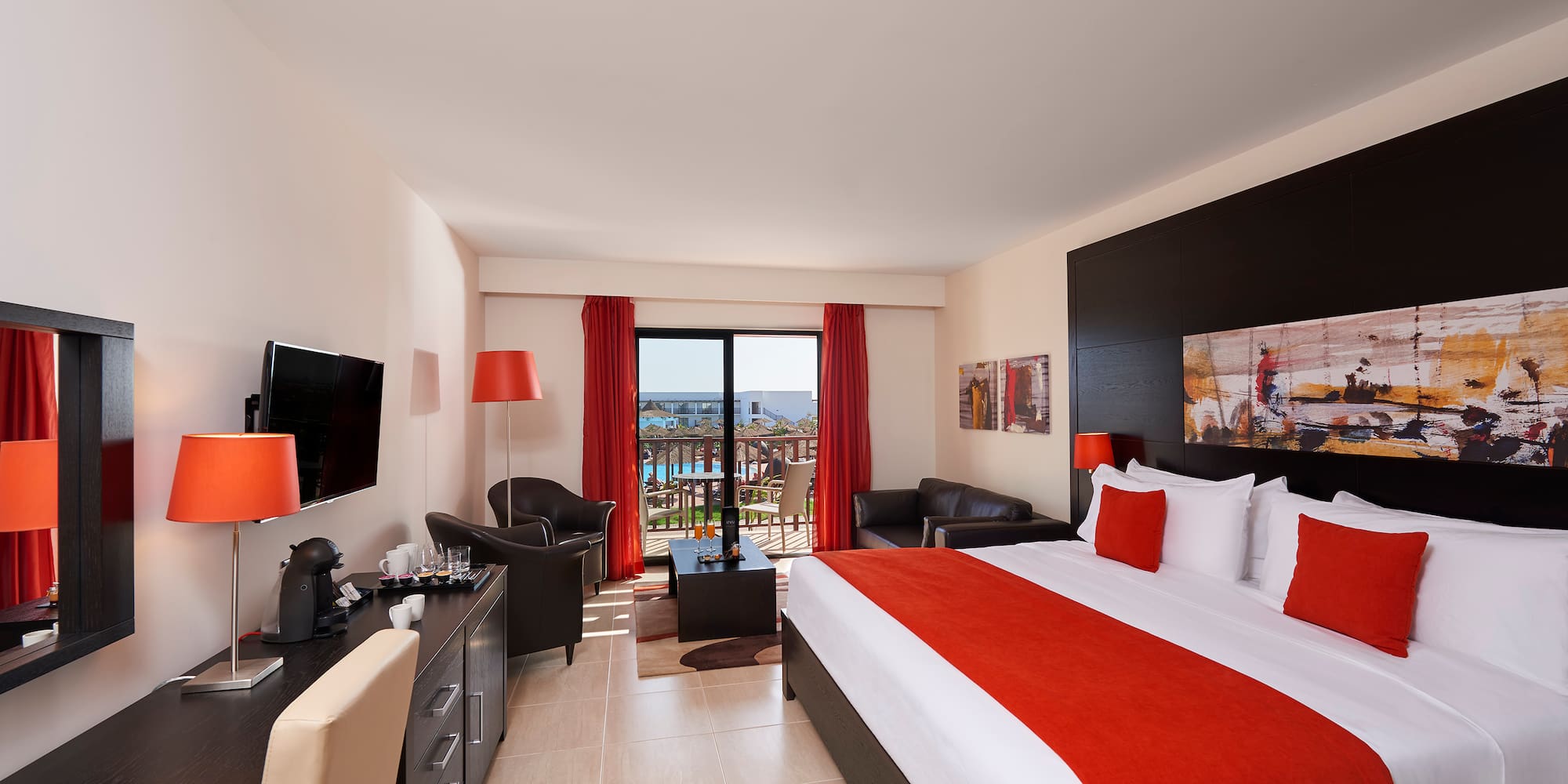 a bedroom with a large bed and a television