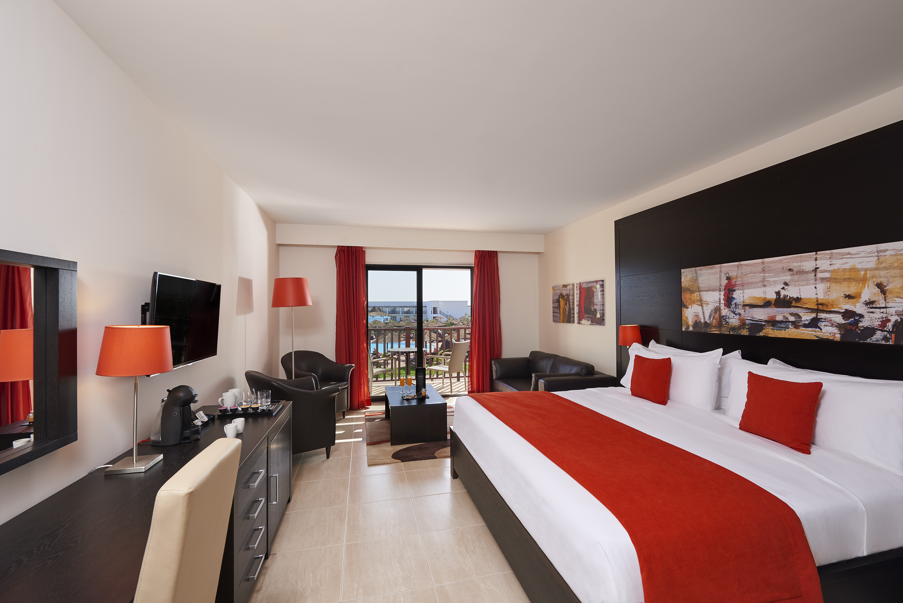 a bedroom with a large bed and a television