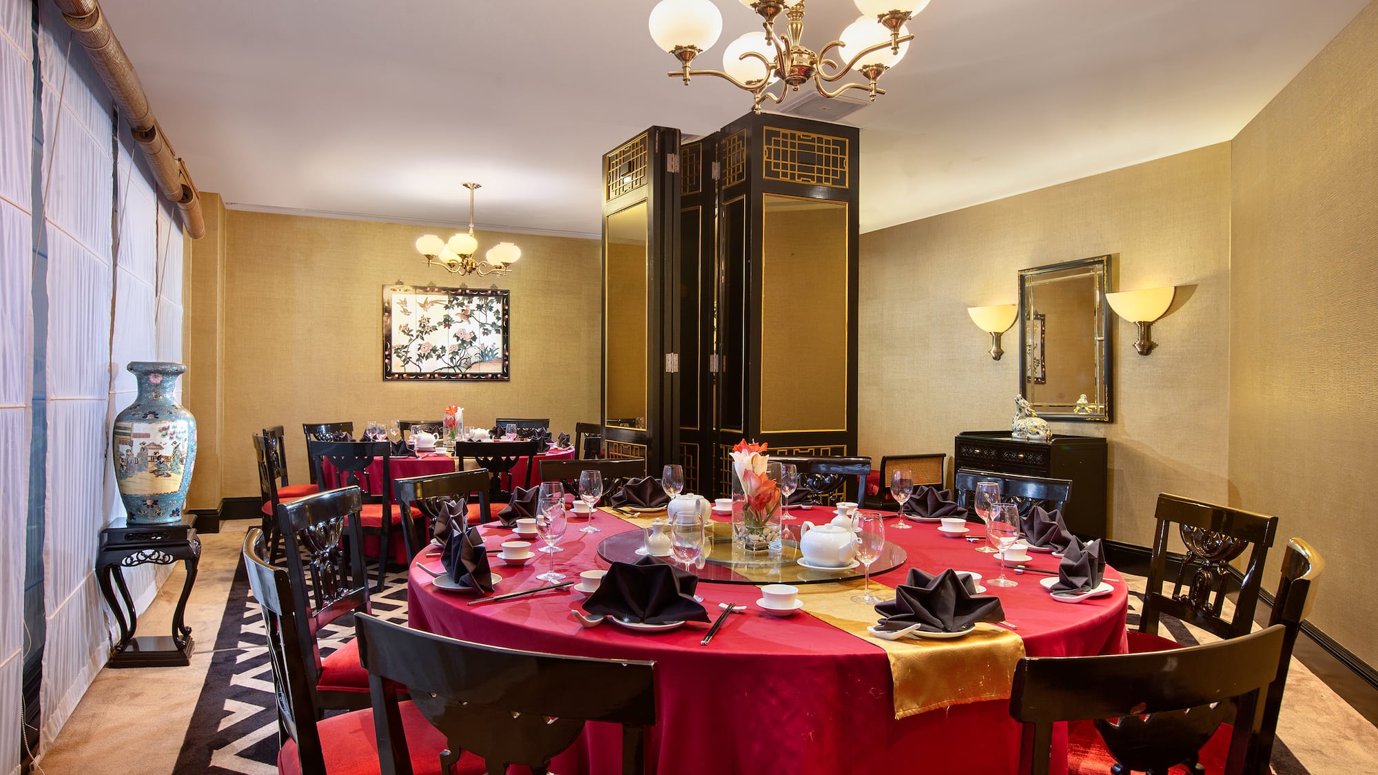a room with a red tablecloth and chairs