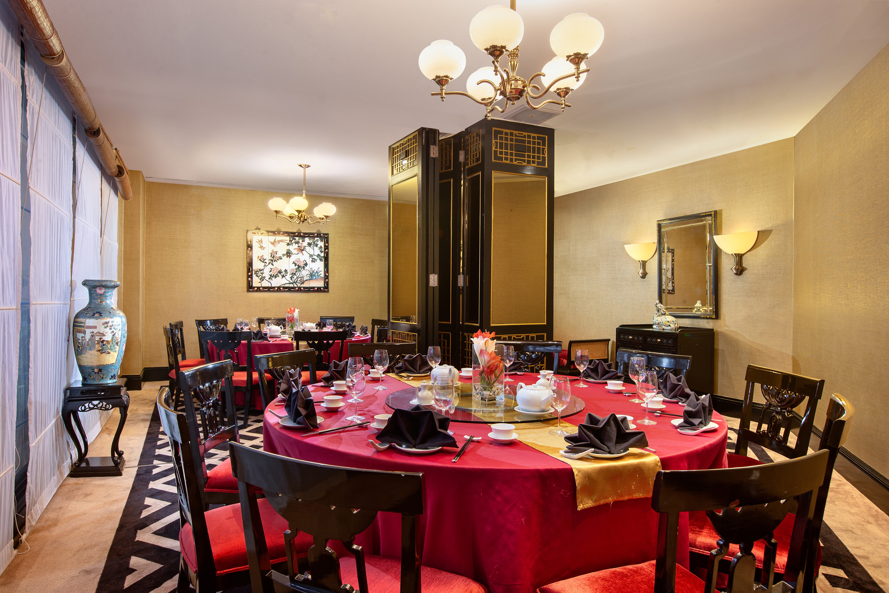 a room with a red tablecloth and chairs