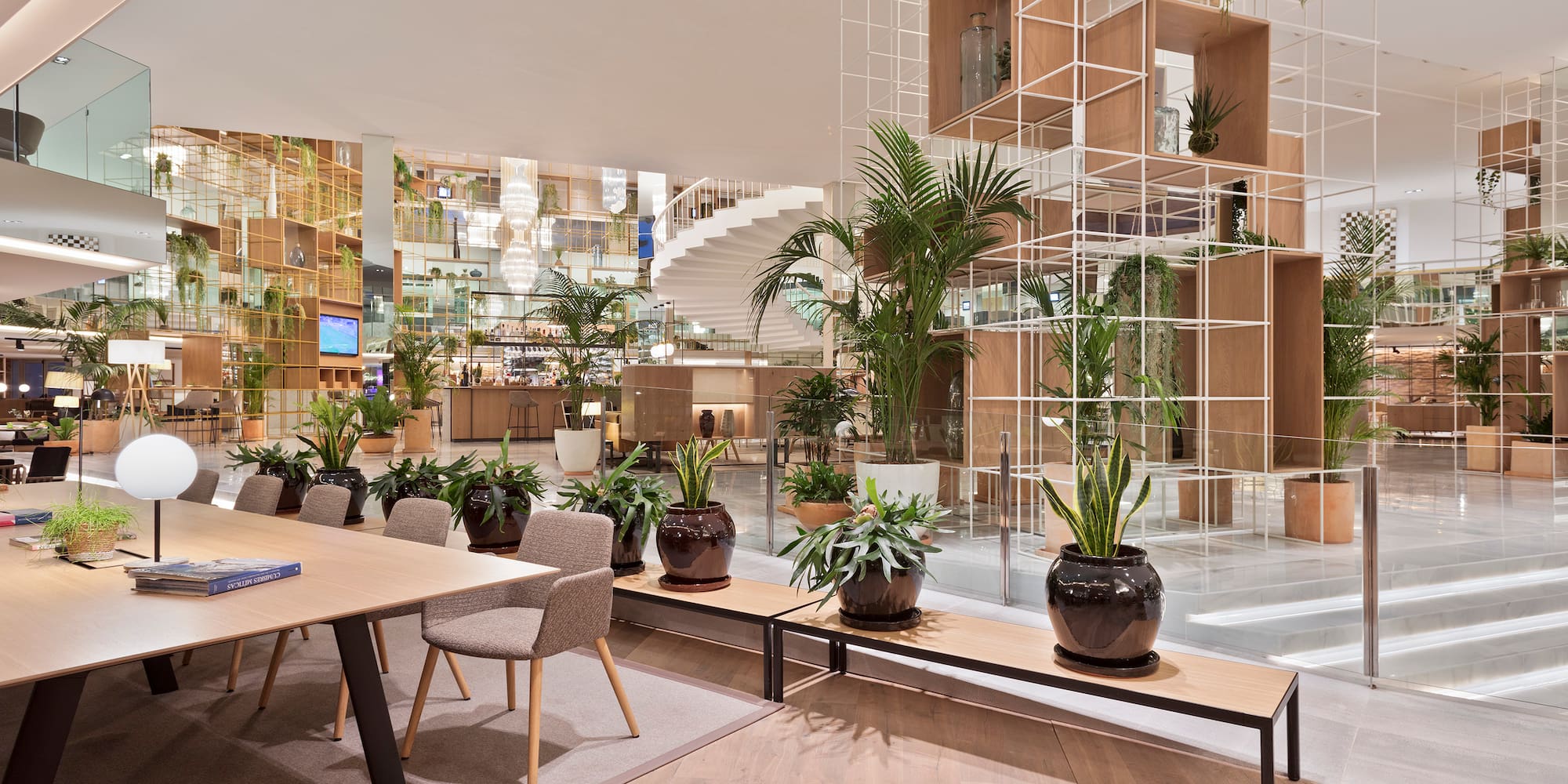 a room with tables and chairs and plants