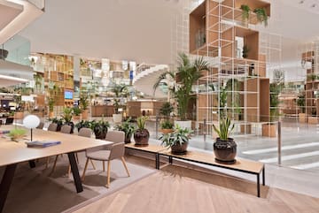 a room with tables and chairs and plants