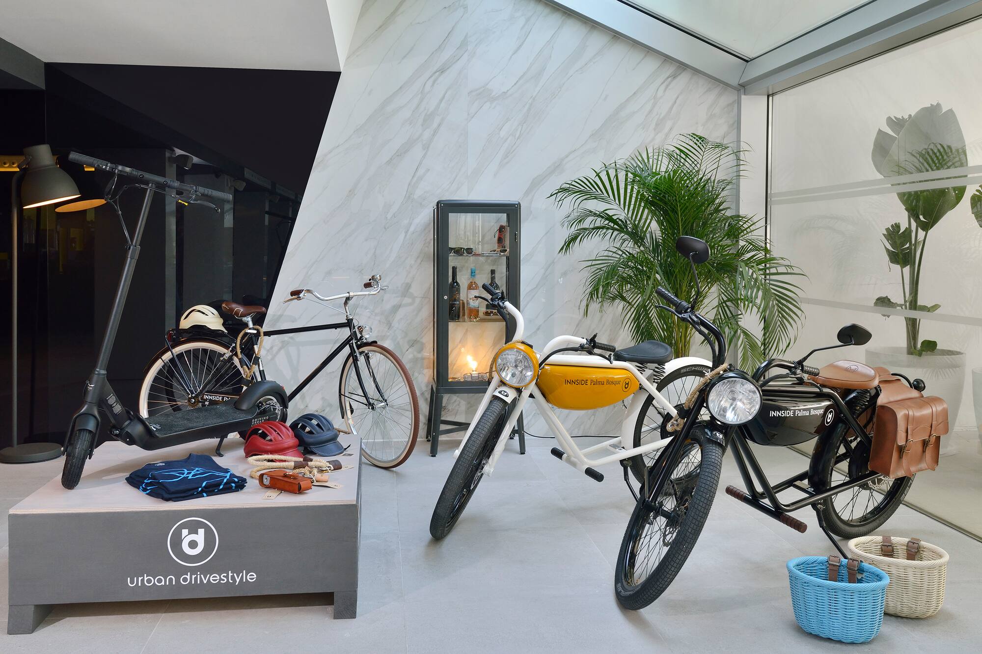 Urban drivestyle showroom with electric scooter, classic bicycle, and vintage e-bikes.