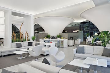 a white and grey room with white furniture