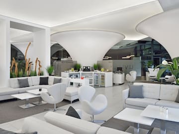 a white and grey room with white furniture