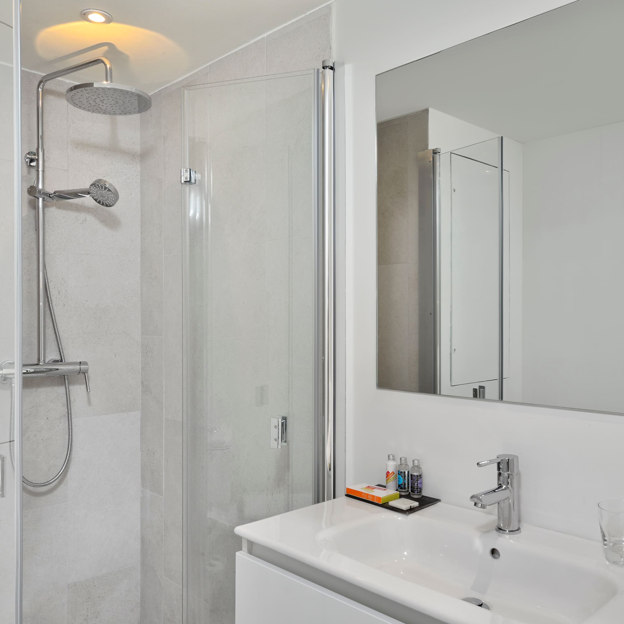 a bathroom with a shower and sink