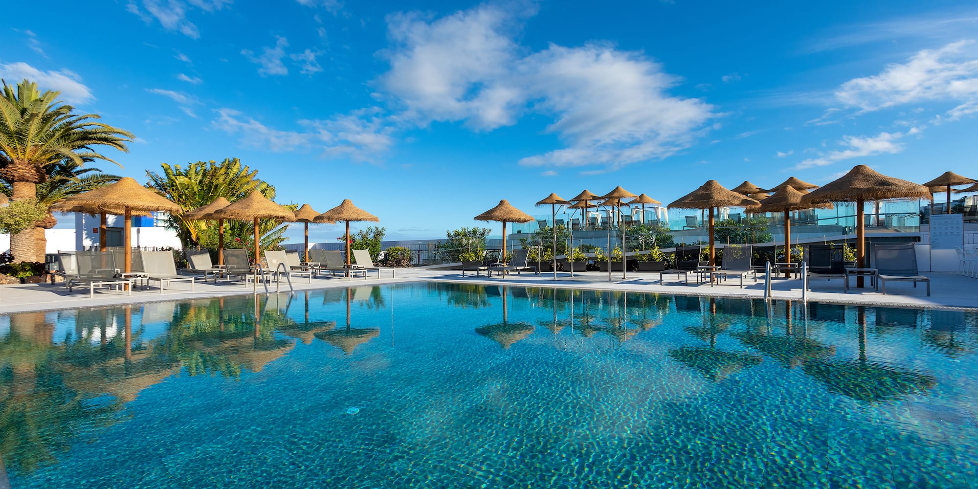 a pool with umbrellas and chairs