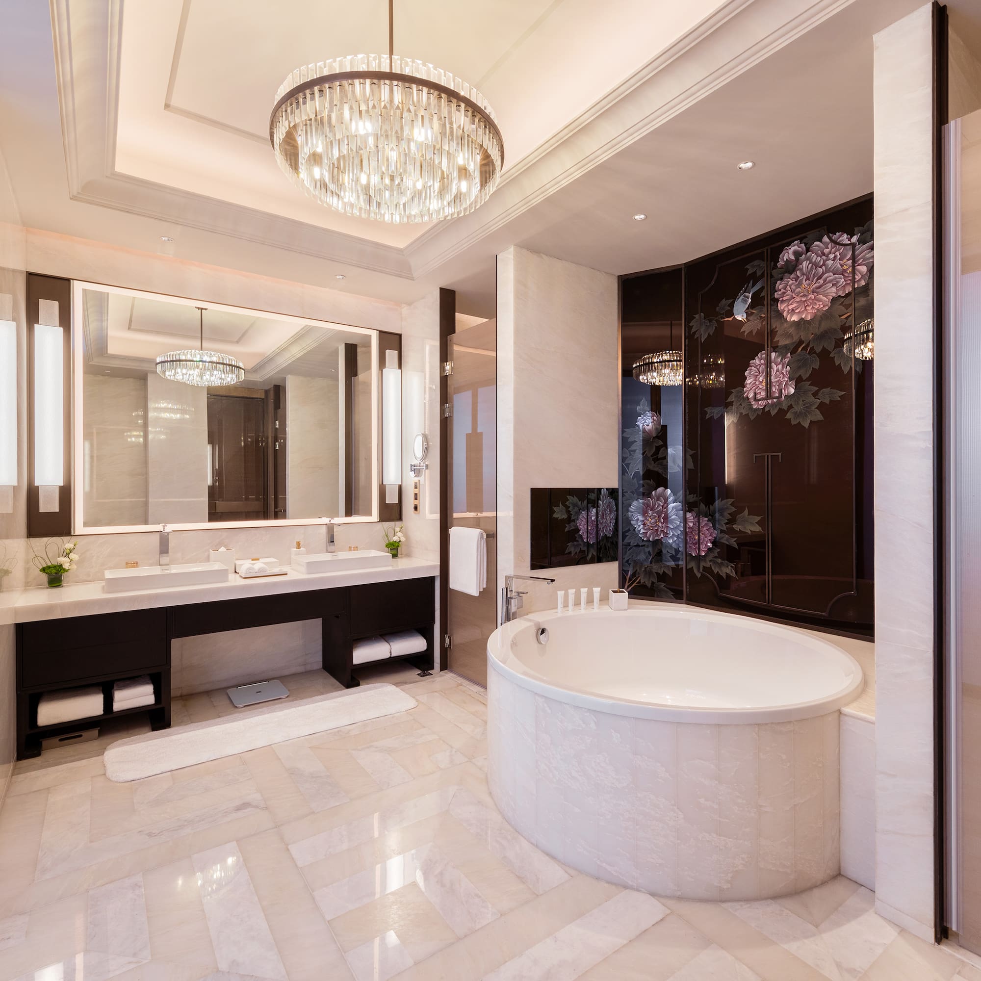 a bathroom with a large tub and a chandelier