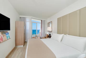 a room with a bed and a table and chairs