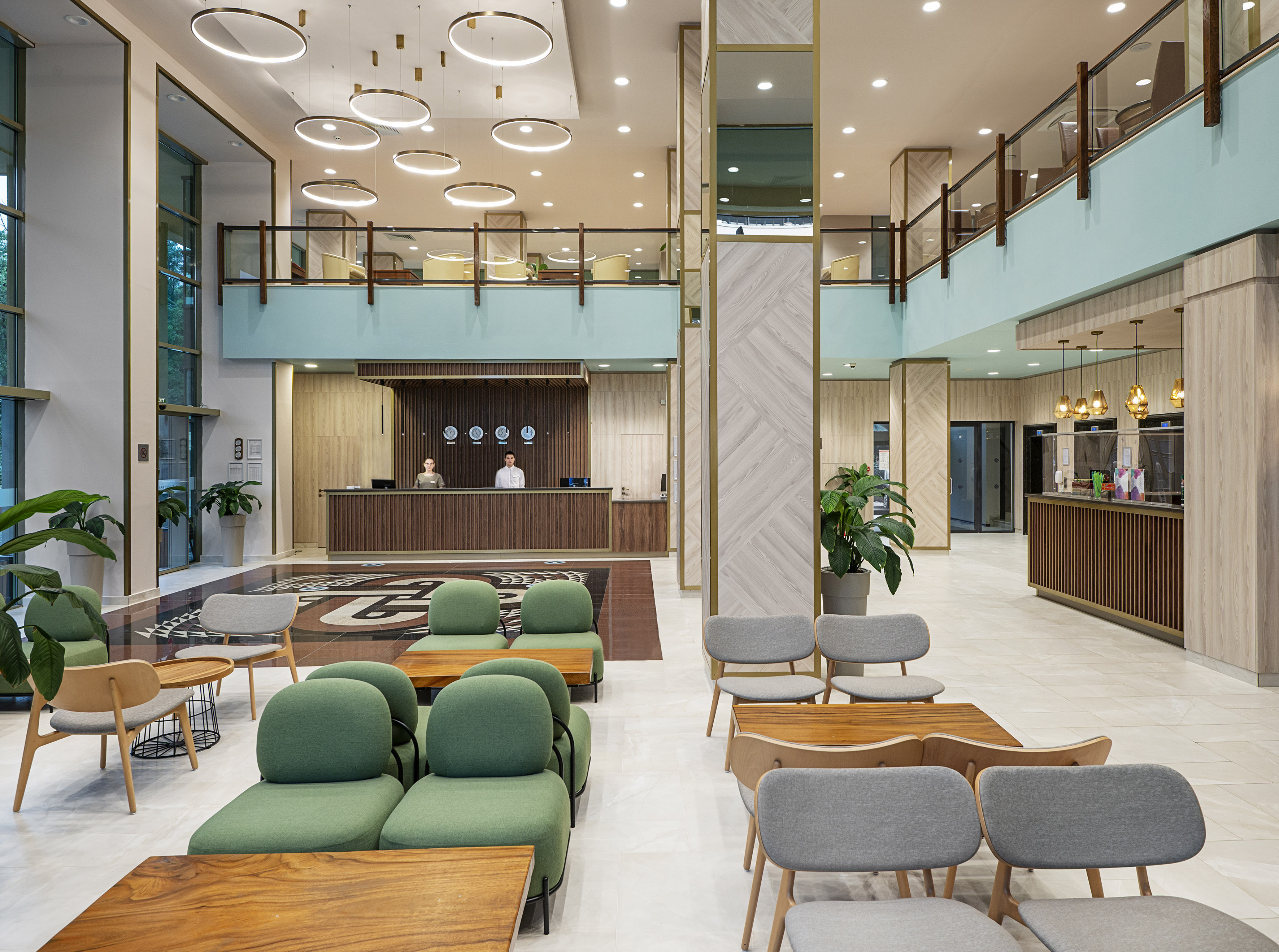 a lobby with a reception desk and chairs