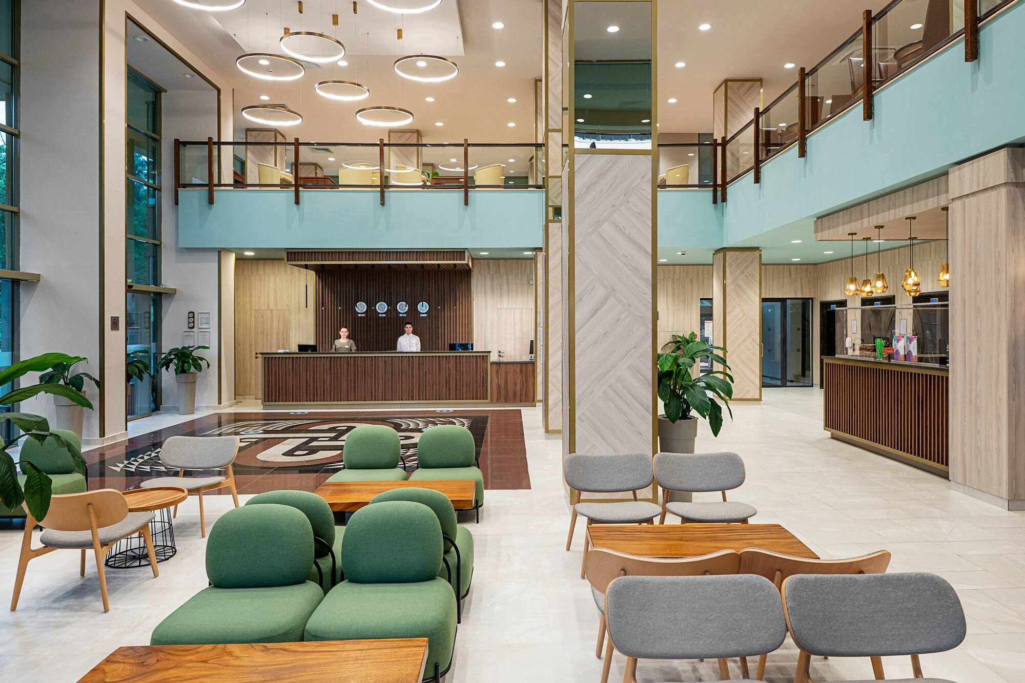 a lobby with a reception desk and chairs