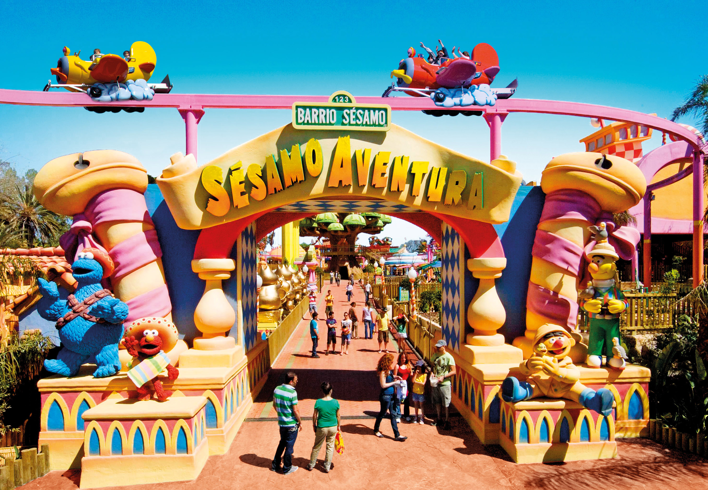 a group of people walking through a colorful archway