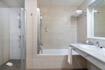 a bathroom with a shower and sink