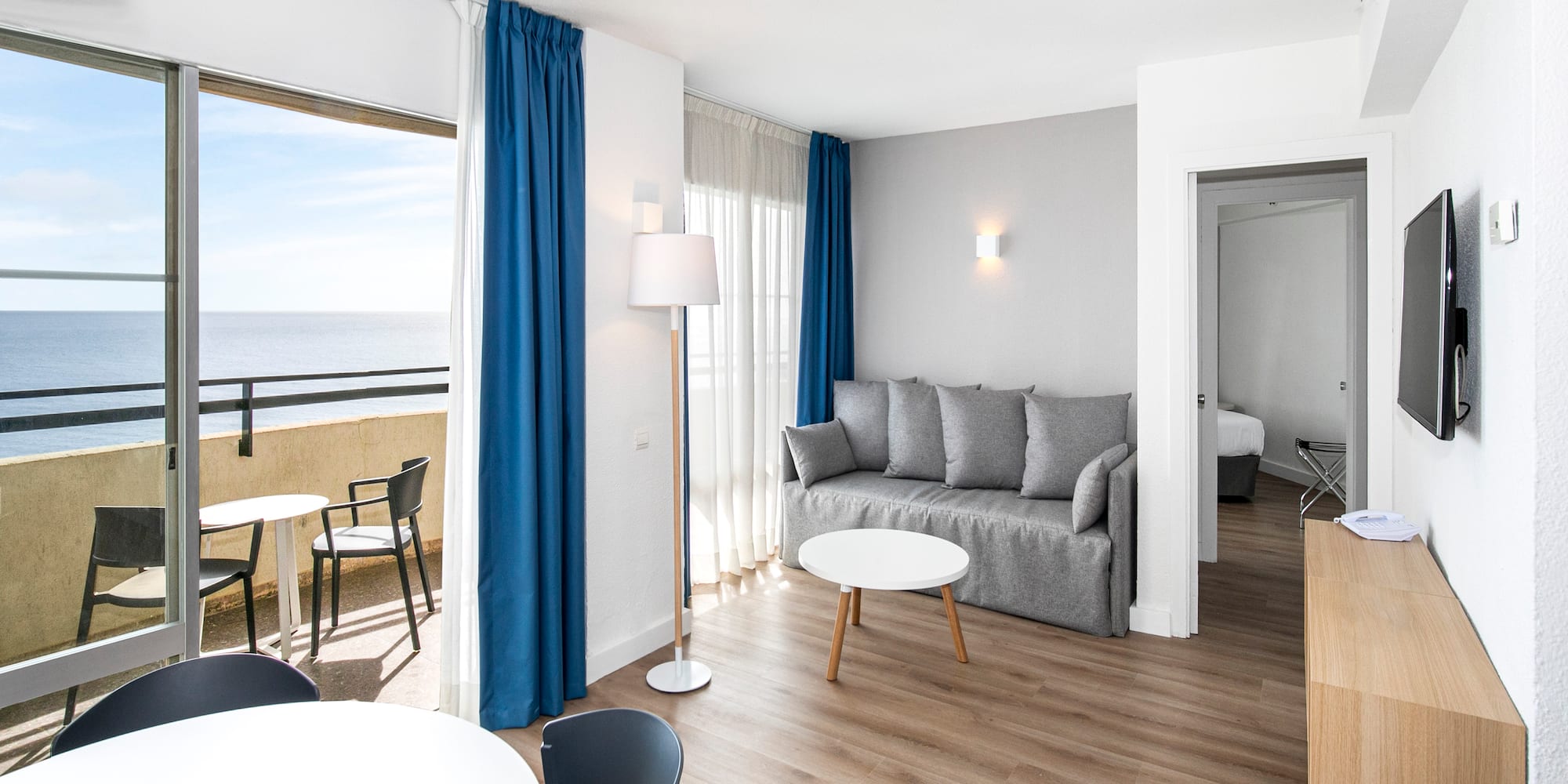 a room with a couch and table and chairs