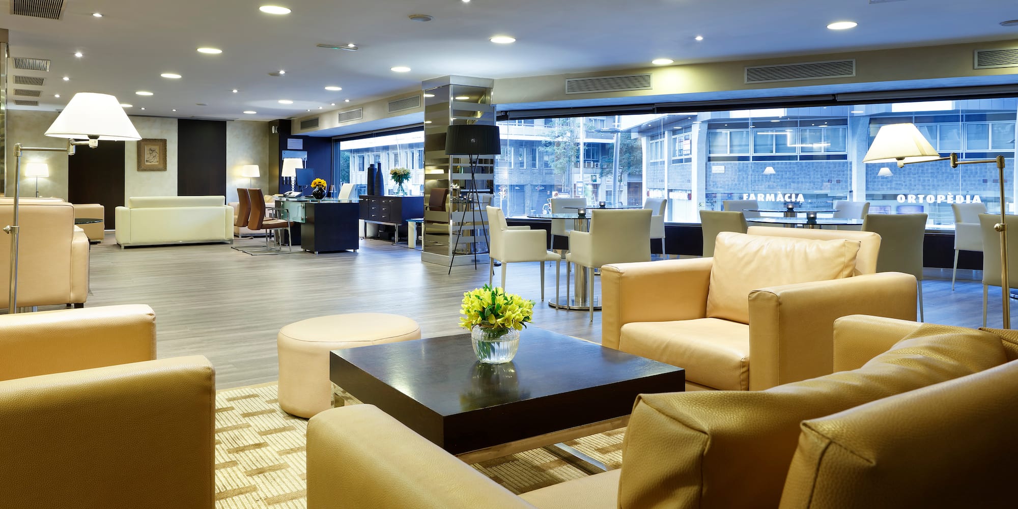 a room with a large window and a large table with chairs