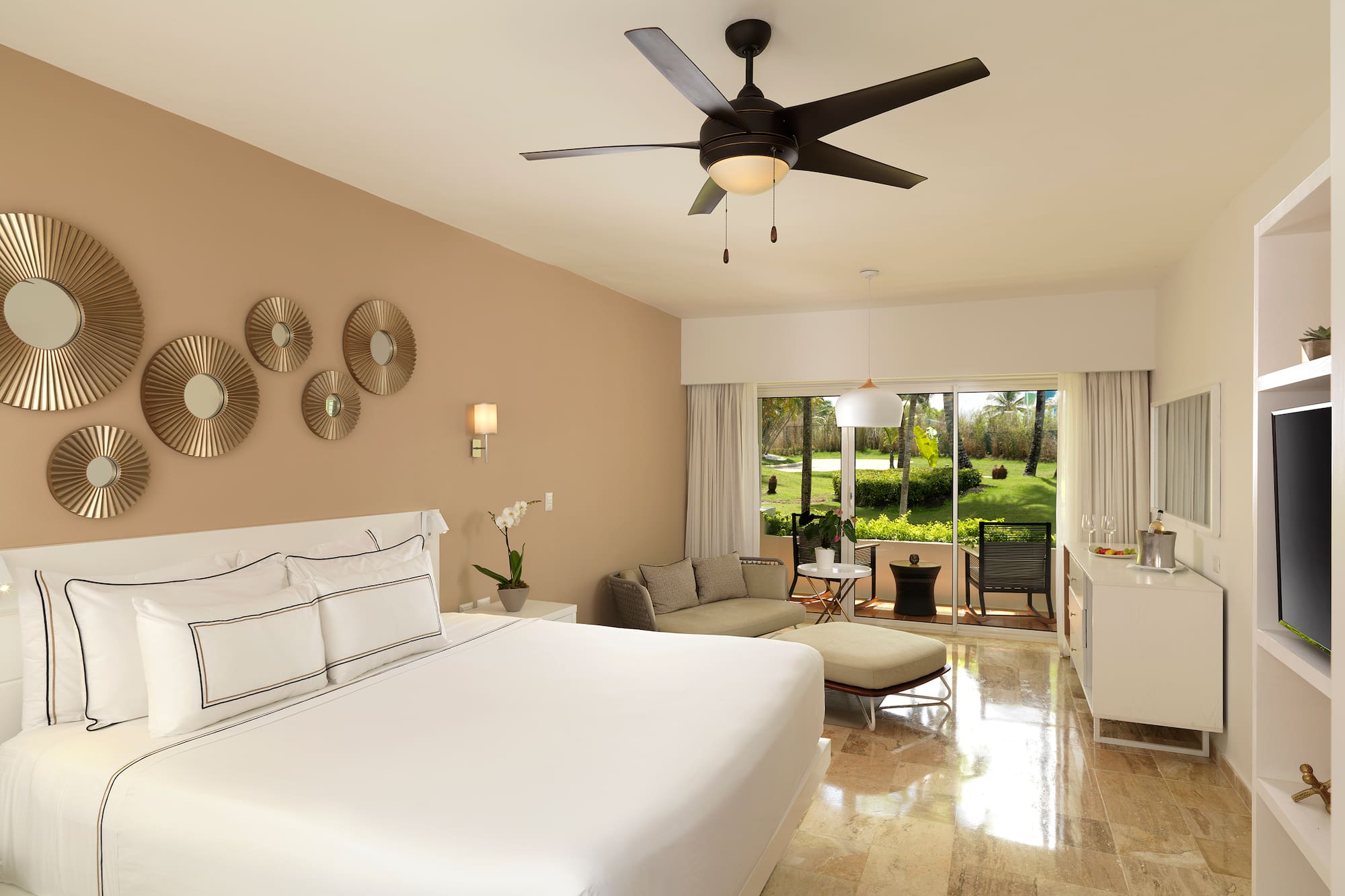 a room with a bed and a ceiling fan