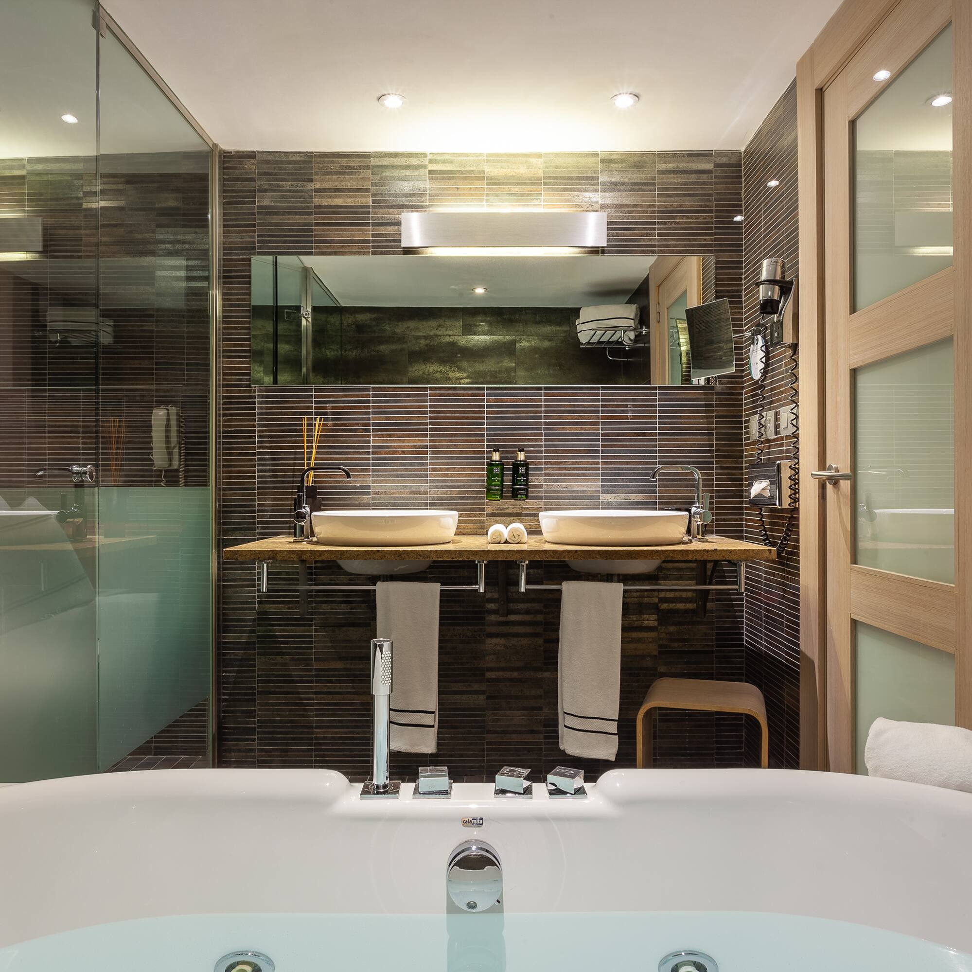 a bathroom with a tub and a shower