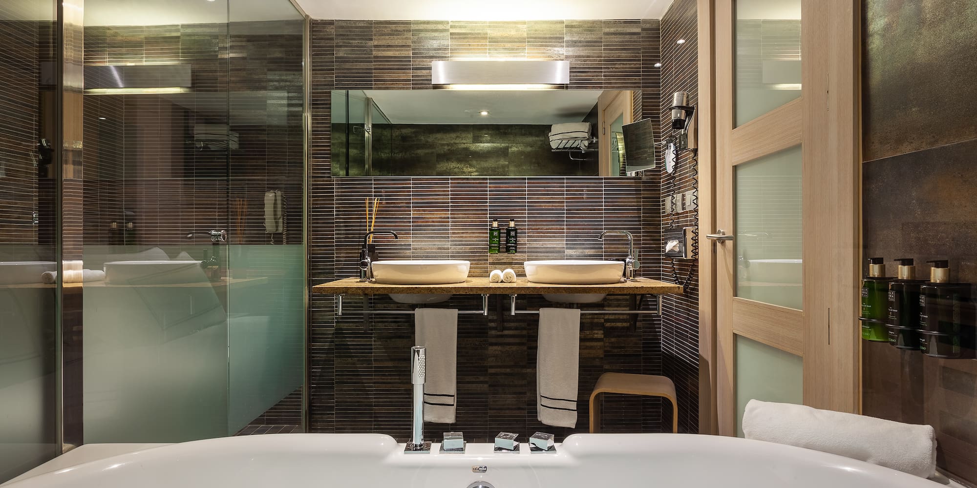 a bathroom with a tub and a shower